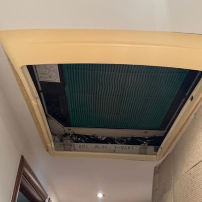 תמונה של מזגן תקרה עם אדם ברקע