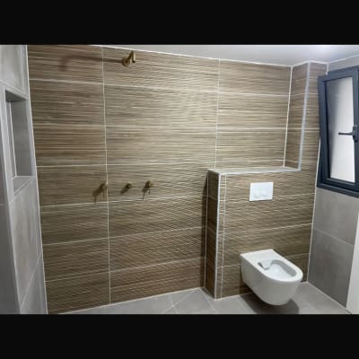 חדר אמבטיה עם אריחים וכלים סניטריים מותקנים