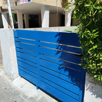 שער כחול עם צמחייה בצד ימין