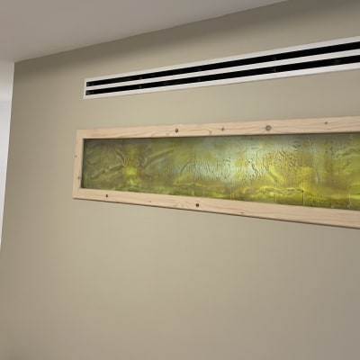 ציור מופשט בצבעים ירוק וצהוב במסגרת עץ