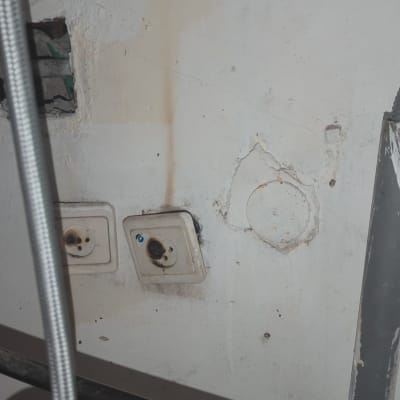 שני שקעים חשמליים עם סימני שריפה על הקיר