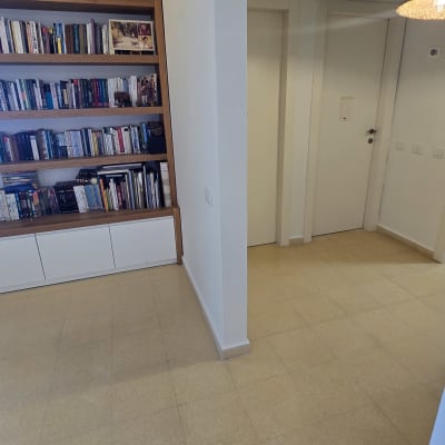 מדף ספרים בחדר עם רצפת אריחים בהירה