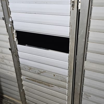 תריסים לבנים עם שלב שבור וחור גדול