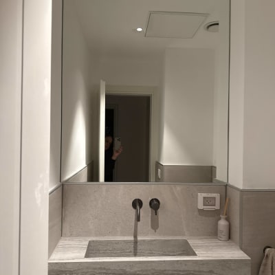 מראה גדולה מעל כיור בחדר אמבטיה מודרני