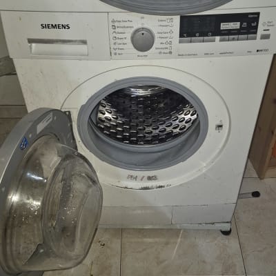 מכונת כביסה פתוחה עם חלקים חשופים