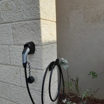 מטען לרכב חשמלי מותקן על קיר אבן