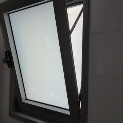 חלון פתוח עם מסגרת מתכת וקיר לבן