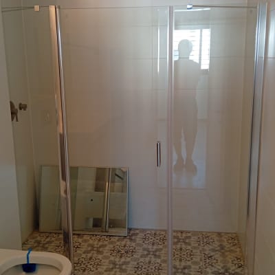 חדר אמבטיה עם מקלחון ודלת זכוכית