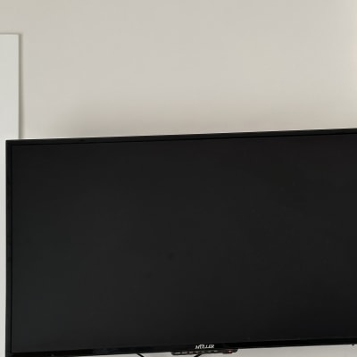 טלוויזיה תלויה על קיר עם כבלים גלויים