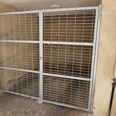 שער מתכת עם רשת במבנה חיצוני