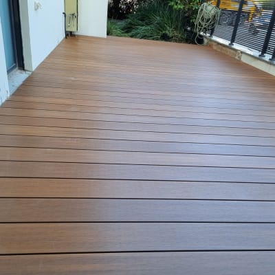 wooden deck with plants and railing