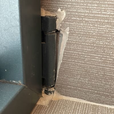 ציר מתכת של תריס עם קיר מתקלף