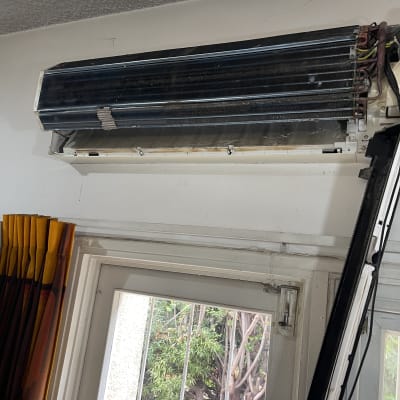 מזגן מפורק על קיר מעל חלון