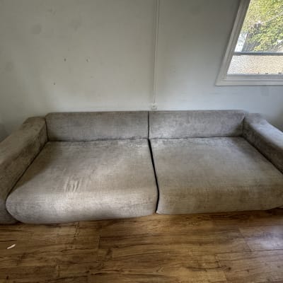 ספה אפורה בחדר עם רצפת עץ