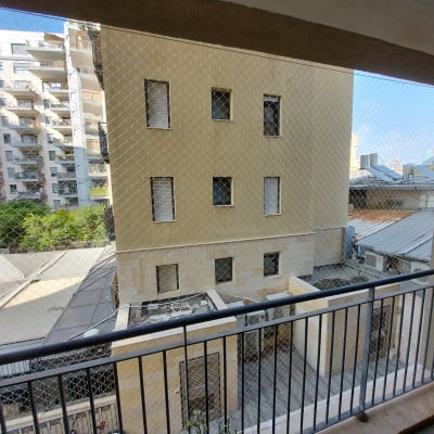 רשת הגנה מותקנת על מרפסת למניעת כניסת יונים