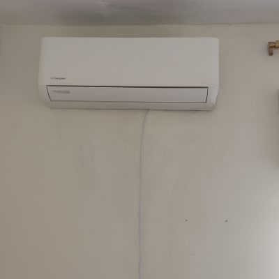 מזגן מותקן על קיר עם חוט חשמל גלוי