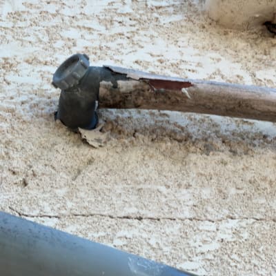 צינור שבור על קיר עם חיבורים