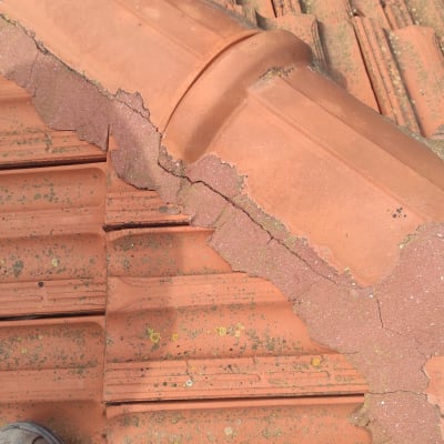 רעפים כתומים עם טחב וסדקים על הגג