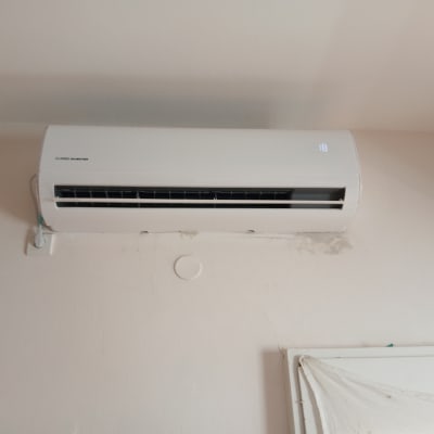 מזגן קיר לבן עם תצוגת טמפרטורה דולקת