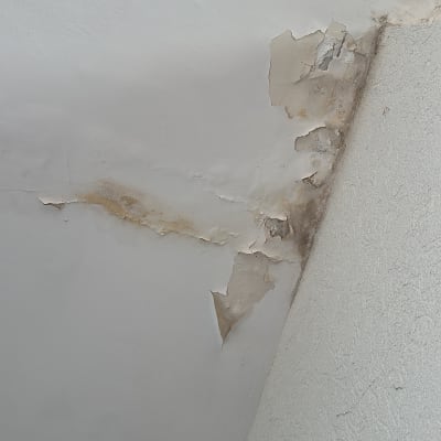 קיר עם סימני רטיבות והתקלפות צבע