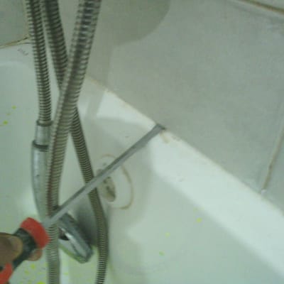תמונה של אמבטיה עם כלי עבודה וצינור מתכת