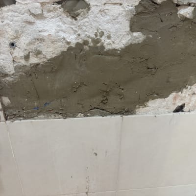 תיקון קיר עם טיח וצינור מים