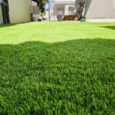 דשא ירוק מלאכותי בחצר מגודרת