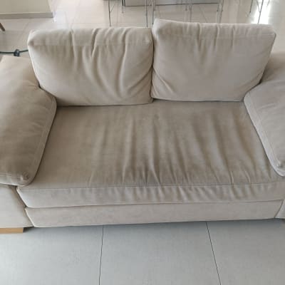 ספה בהירה בחדר מגורים עם רצפת קרמיקה