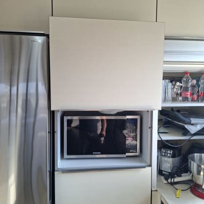 מיקרוגל מותקן בארון מטבח עם מכשירי חשמל נוספים