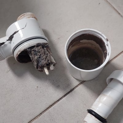 חלקי צנרת מפורקים עם לכלוך על רצפה