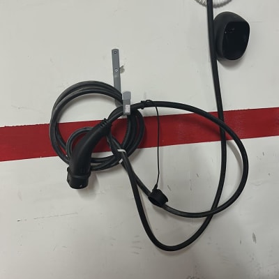 מטען קיר לרכב חשמלי עם כבל תלוי על הקיר