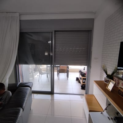 תריסים סגורים על חלון זכוכית גדול בסלון