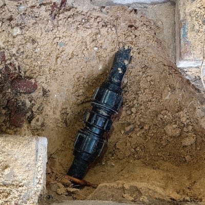 חיבור צינור פלסטיק שחור באדמה