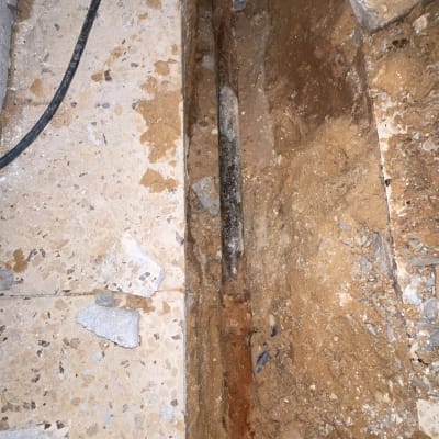 תמונה של צינור ישן בתעלה באדמה