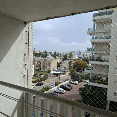 מרפסת עם רשת בטיחות ונוף עירוני