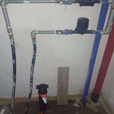 צינורות מים עם ברזים ומד מים על קיר