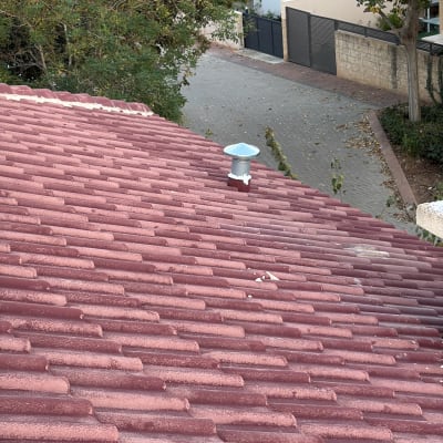 גג רעפים אדום עם ארובה קטנה במרכז