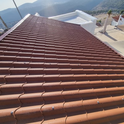 גג רעפים חום עם נוף הררי ברקע