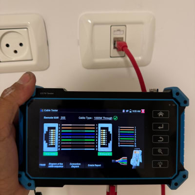 בודק כבלים מחובר לשקע רשת על קיר