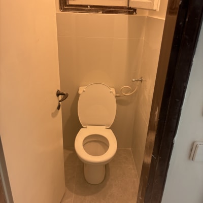 שירותים נקיים עם אסלה פתוחה וחלון קטן