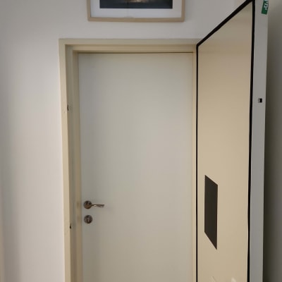 דלת לבנה עם ידית מתכת פתוחה חלקית