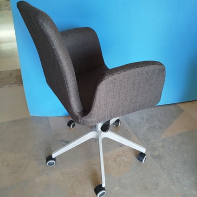 כיסא מרופד עם גלגלים על רקע כחול