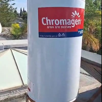 דוד שמש כרומגן על גג עם צמחייה ברקע