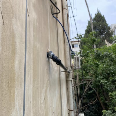 צינור מים מחובר לקיר חיצוני של בניין