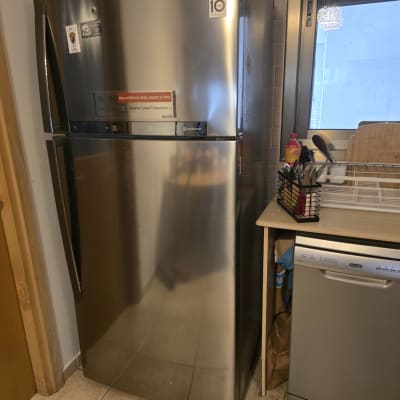 מקרר נירוסטה במטבח ליד מדיח כלים