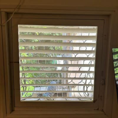 חלון זכוכית עם תריסים פתוחים חלקית