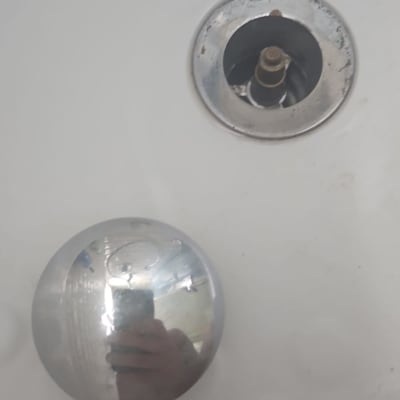 חלקי ברז מתכתיים מפורקים על משטח לבן