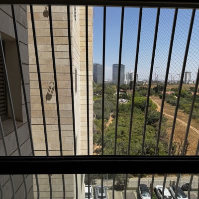 סורגים על חלון עם נוף לעיר ולבניינים