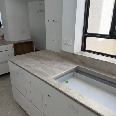 משטח שיש במטבח עם ארונות לבנים