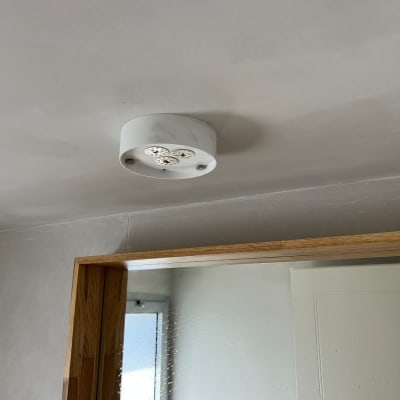 ceiling with a light fixture and a mirror reflection